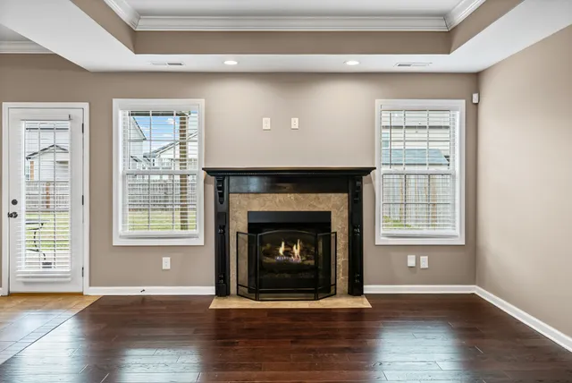 a living room with a fireplace with wooden floor