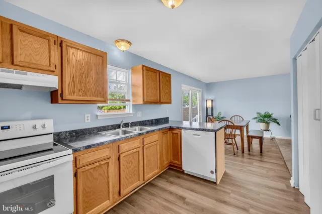 a kitchen with a sink and wooden cabinets