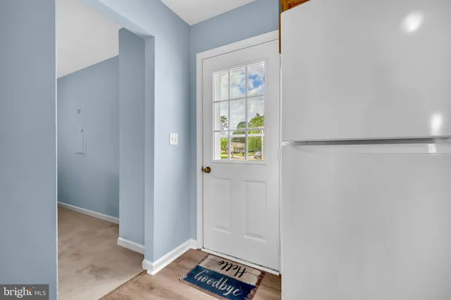 a view of an empty room and wooden floor