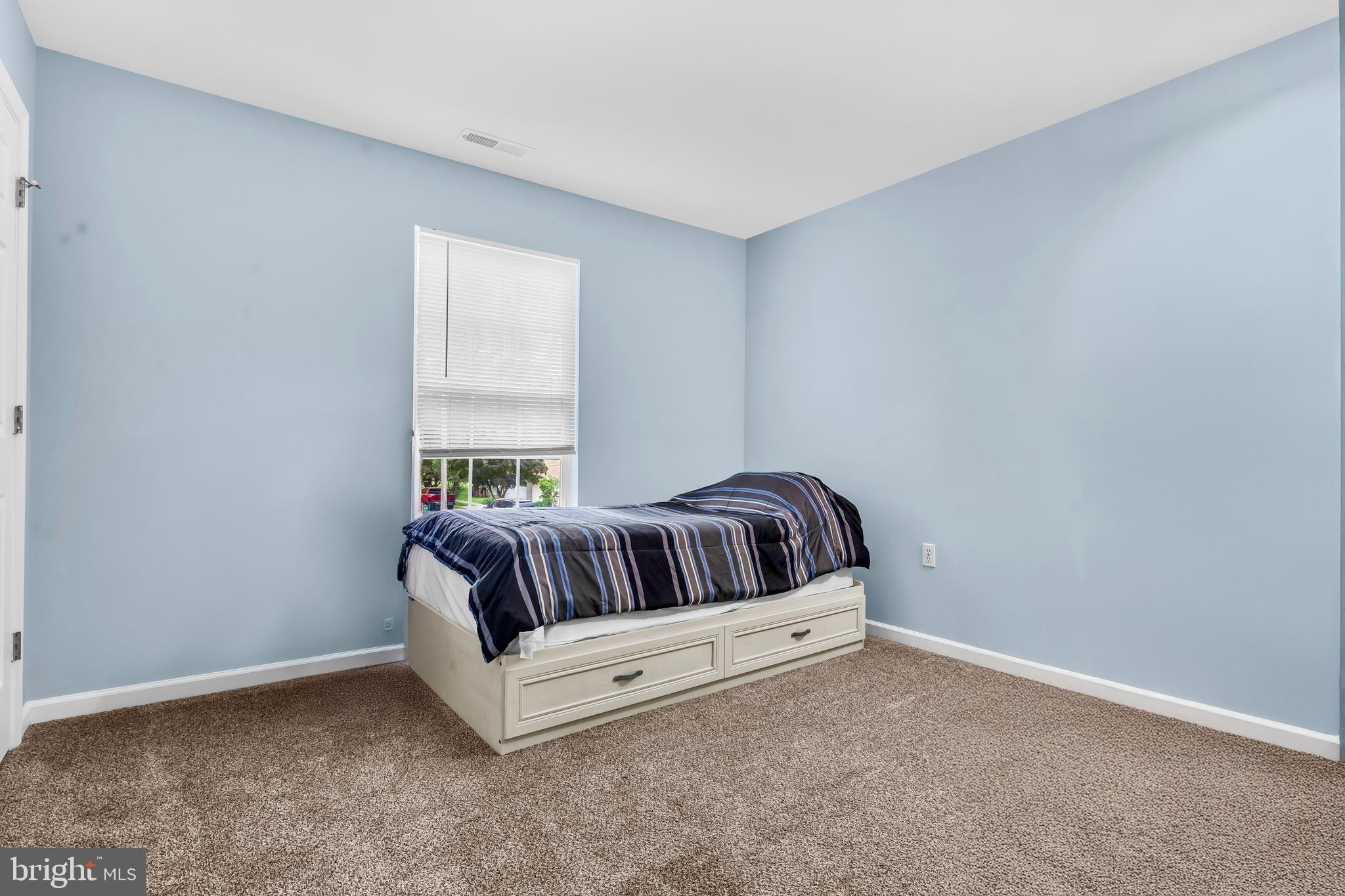 202 Maryland Avenue Ridgely, MD 21660 - Photo 10 of 18 a white bed sitting in a room next to a window