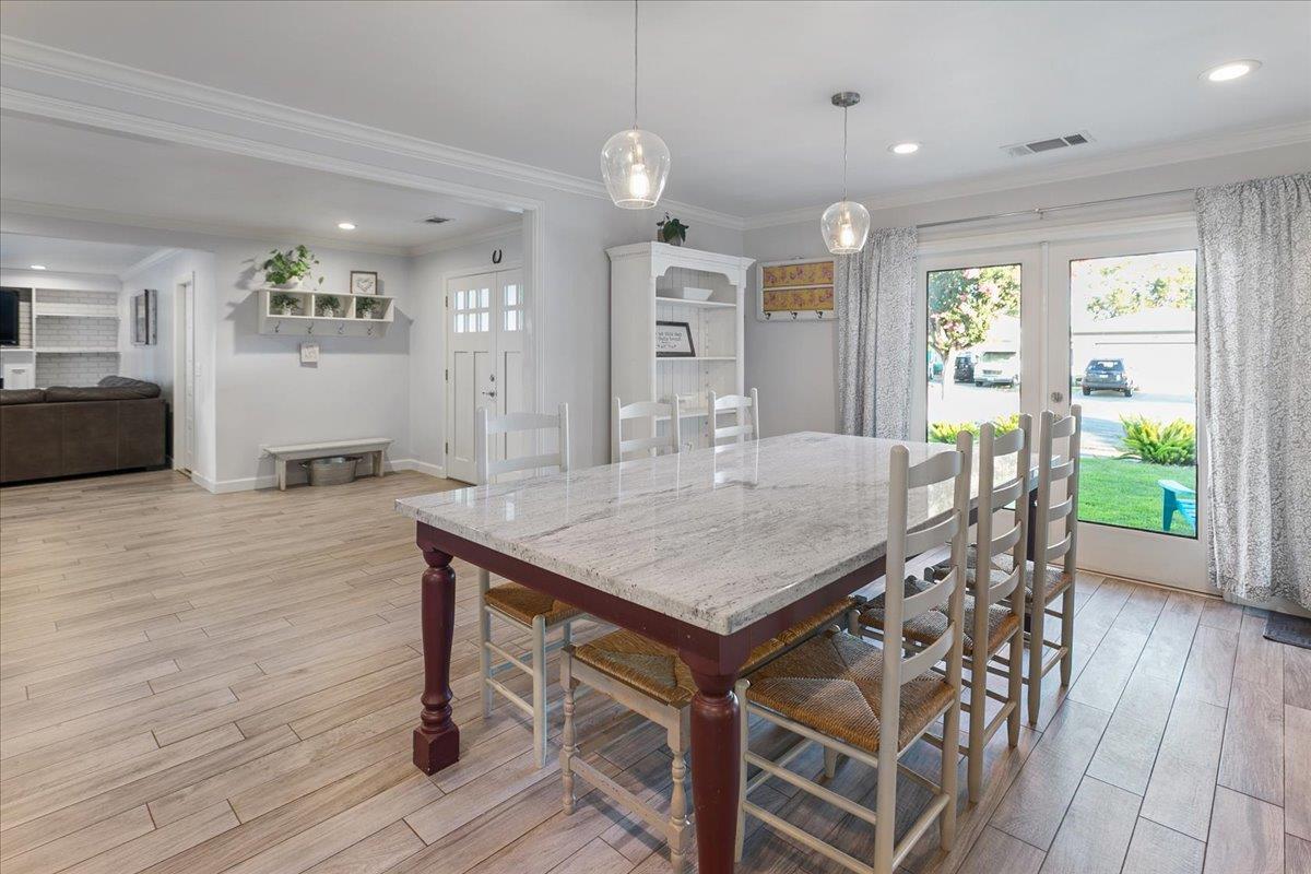 751 Eschenburg Drive Gilroy, CA 95020 - Photo 18 of 39 a dining hall with stainless steel appliances granite countertop a kitchen island a stove a refrigerator a sink with a dining table and chairs