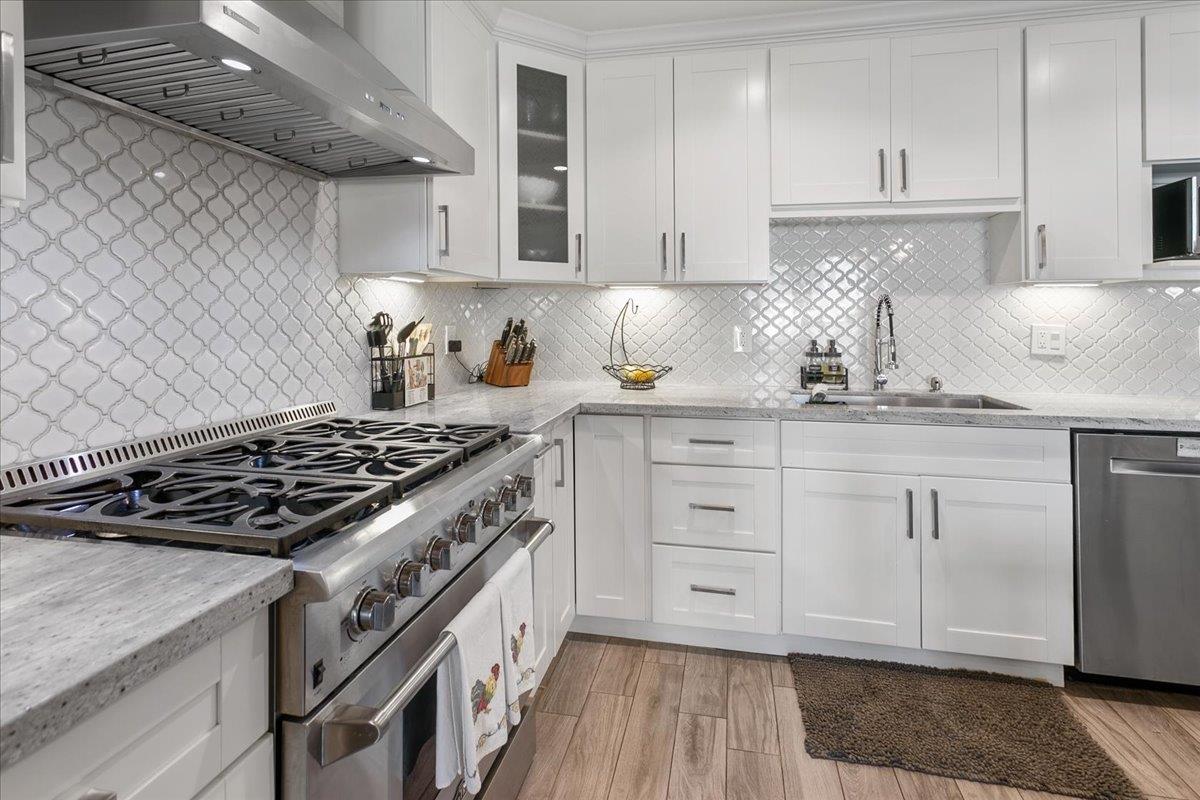 751 Eschenburg Drive Gilroy, CA 95020 - Photo 20 of 39 a kitchen with white cabinets and appliances