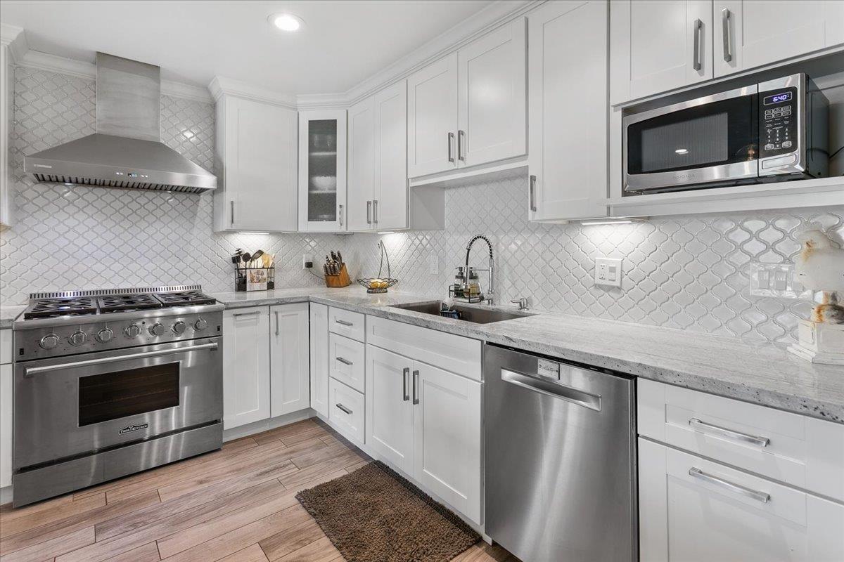 751 Eschenburg Drive Gilroy, CA 95020 - Photo 21 of 39 a kitchen with cabinets stainless steel appliances and wooden floor