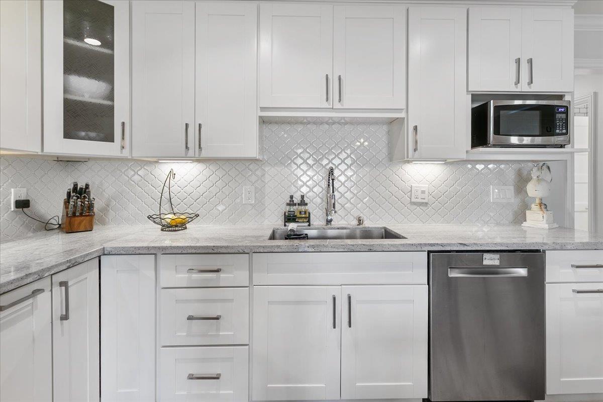 751 Eschenburg Drive Gilroy, CA 95020 - Photo 22 of 39 a kitchen with white cabinets and appliances