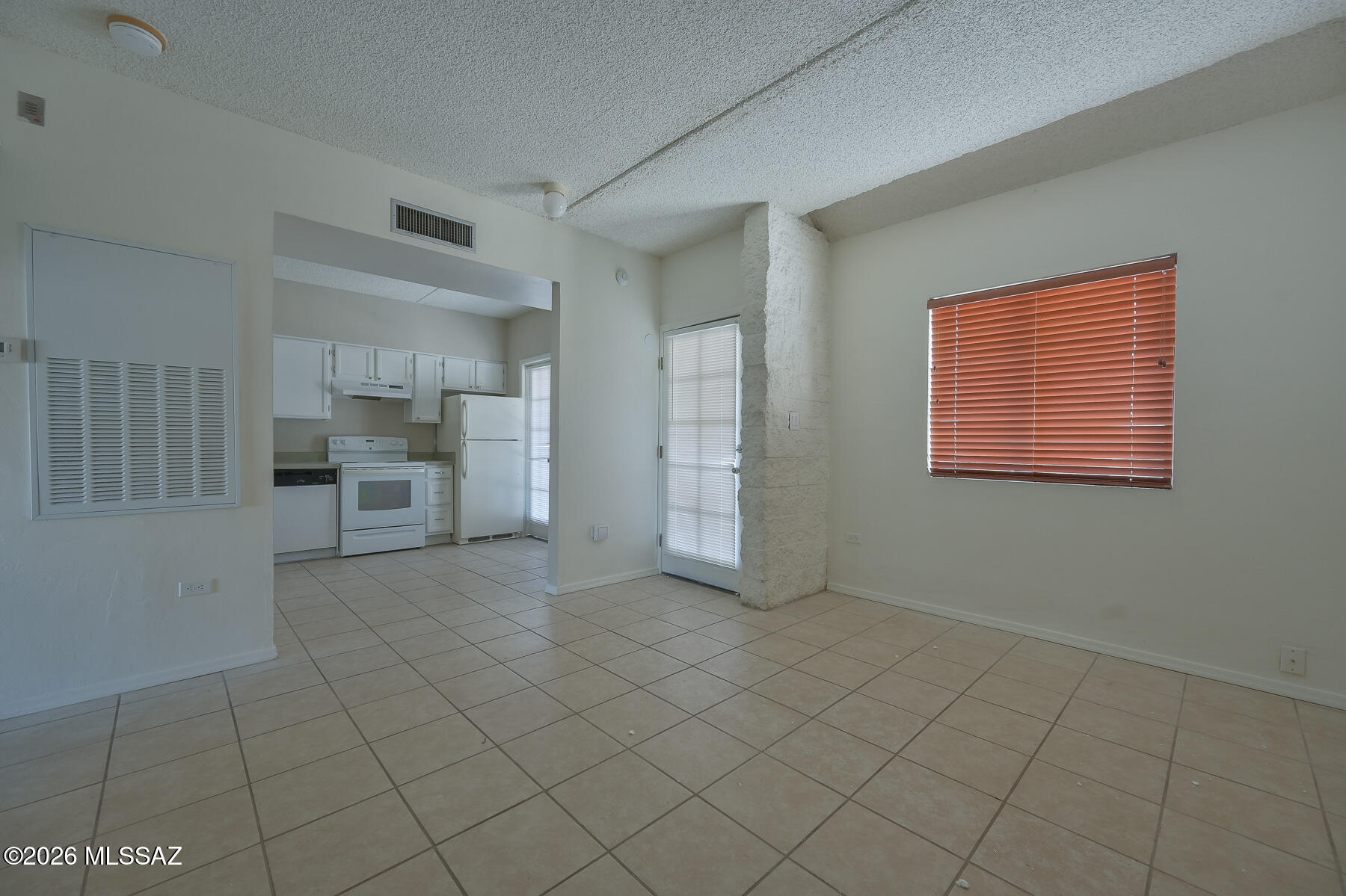 7777 East Golf Links Road, Unit 2308 Tucson, AZ 85730 - Photo 13 of 37 a view of an empty room with a fireplace