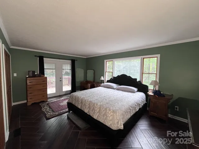 a bedroom with a bed and dresser with mirror