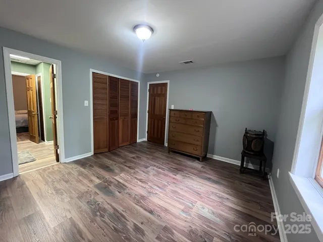 a view of room with furniture and wooden floor