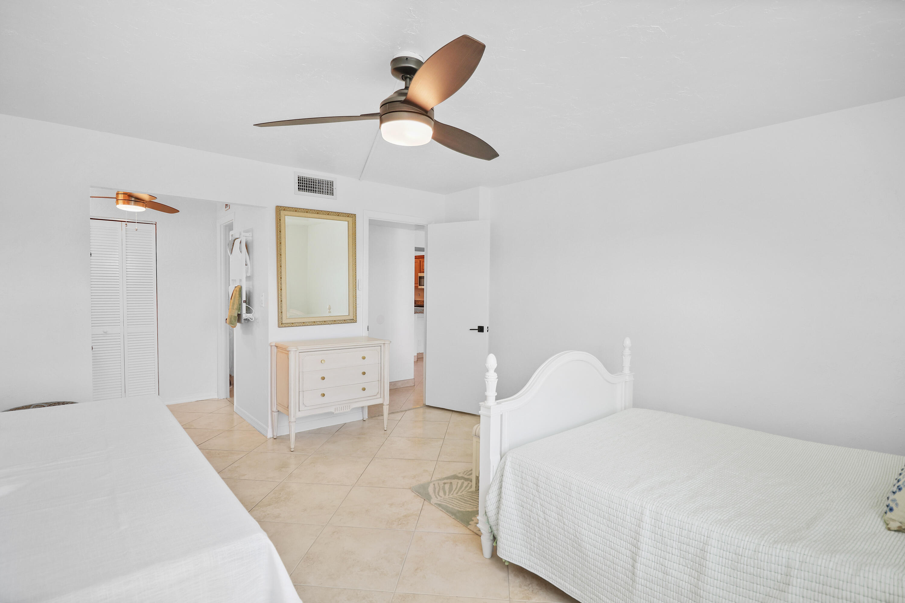 13 Royal Palm Way, Unit 302 Boca Raton, FL 33432 - Photo 14 of 31 a bedroom with a bed and cabinets