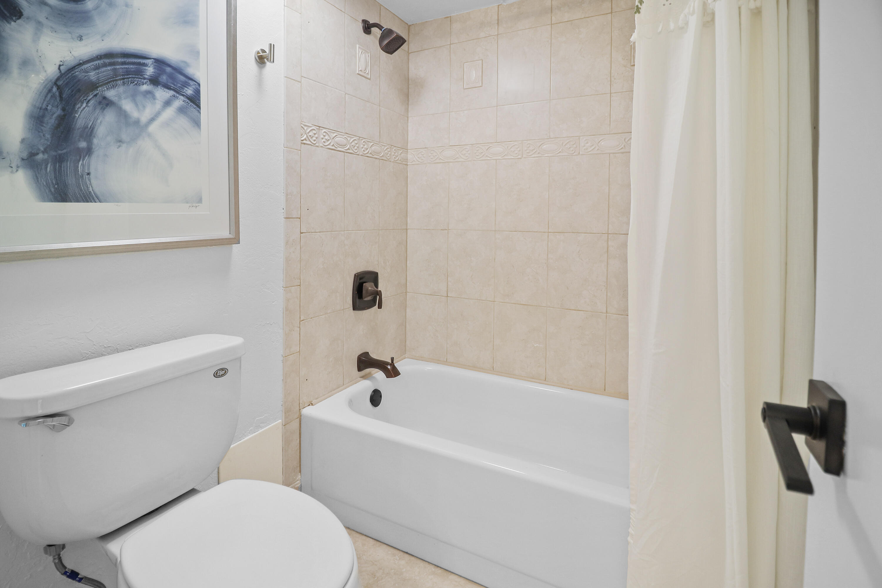 13 Royal Palm Way, Unit 302 Boca Raton, FL 33432 - Photo 16 of 31 a bathroom with a toilet and a tub