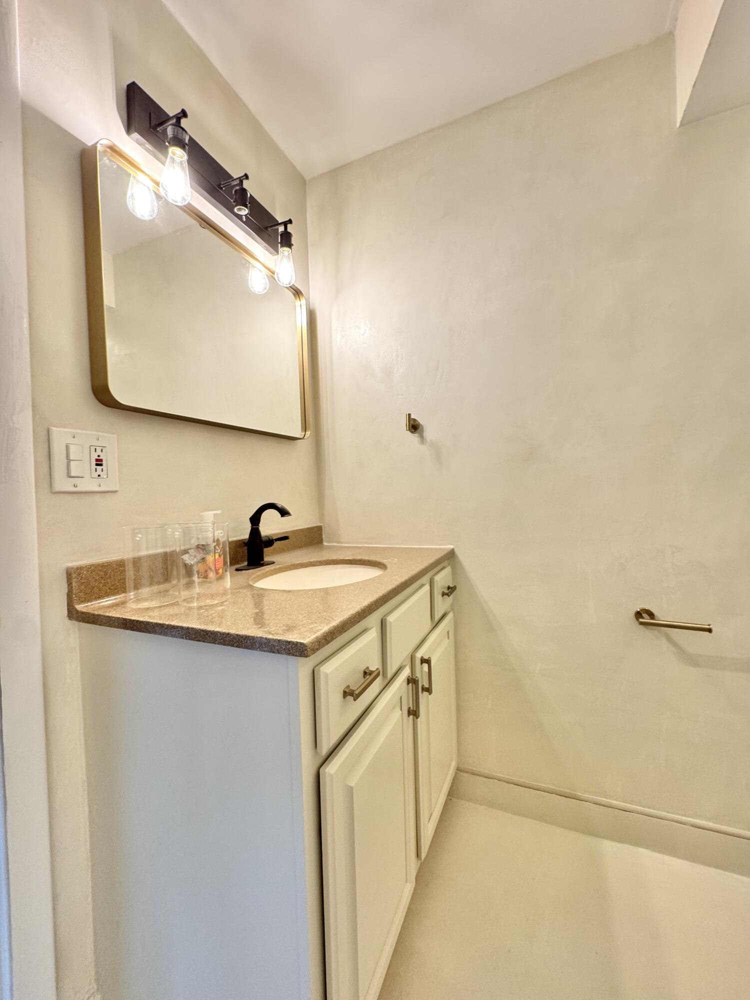 13 Royal Palm Way, Unit 302 Boca Raton, FL 33432 - Photo 19 of 31 a bathroom with a sink and a mirror