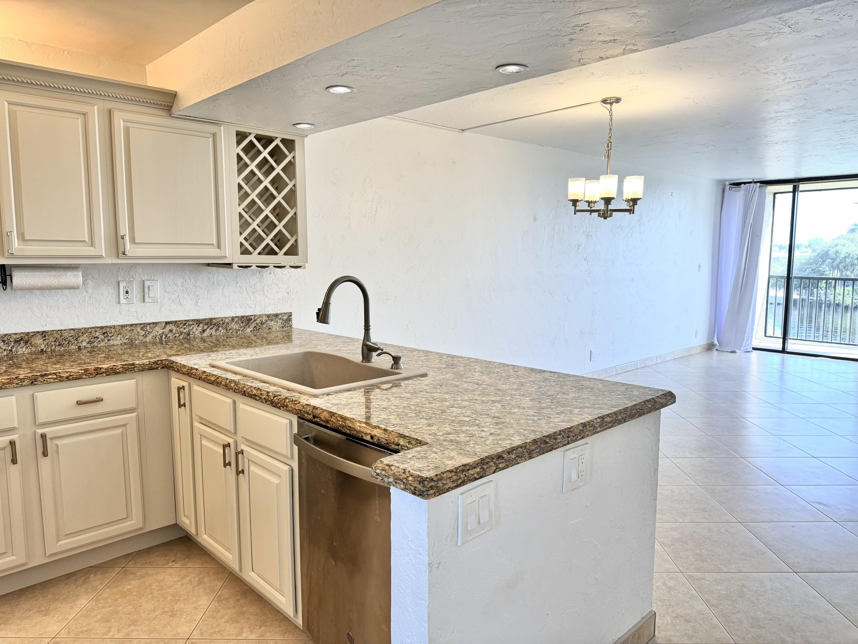 13 Royal Palm Way, Unit 302 Boca Raton, FL 33432 - Photo 4 of 31 a kitchen with a sink cabinets and window