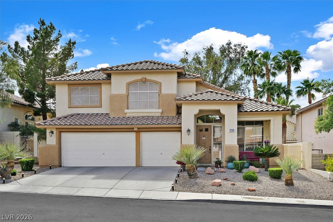 1259 Moon Vision Street Henderson, NV 89052 - Photo 1 of 53 A well-maintained facade with a two-car garage and drought-tolerant landscaping offers charming curb appeal.