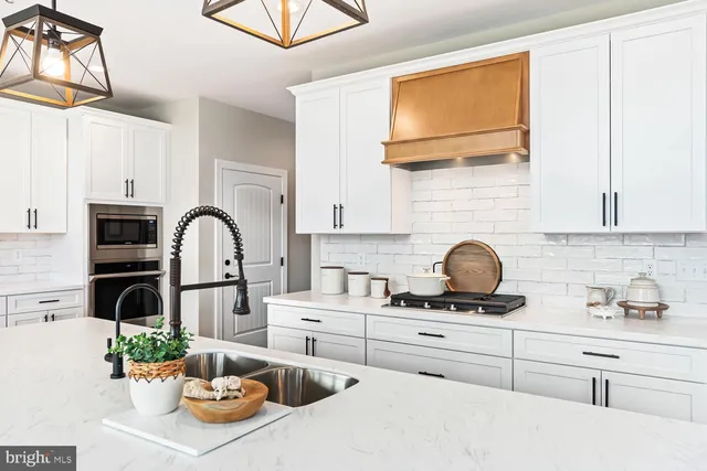 a kitchen with center island dining table and a sink