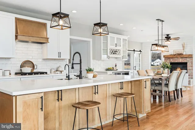 a view of a dining room with furniture wooden floor and a fireplace