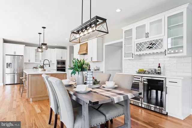 a living room with fireplace furniture and a large window