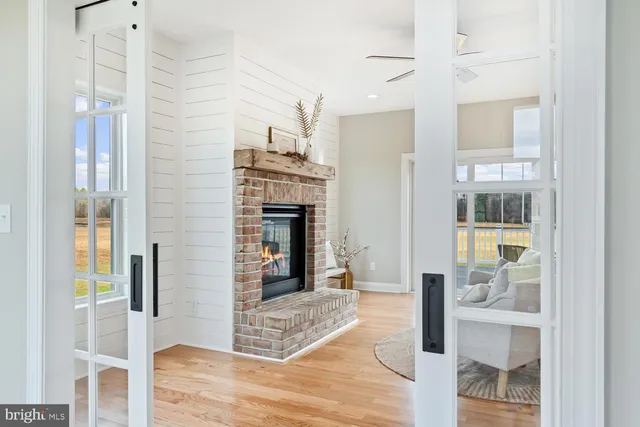 a kitchen with stainless steel appliances white cabinets and wooden floors