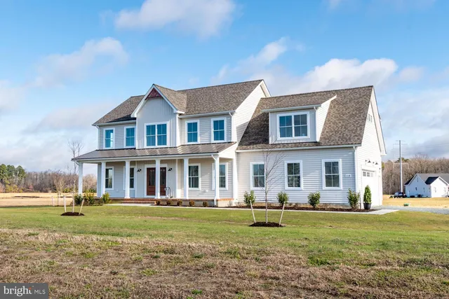 a front view of a house with a yard table and chairs