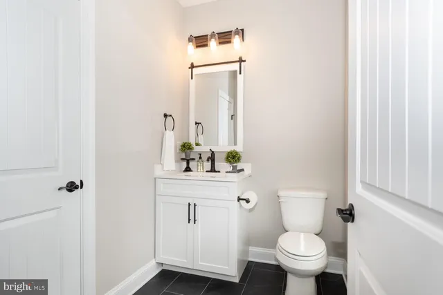 a view of a hallway with wooden floor and stairs