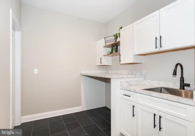 a bathroom with a sink a toilet a mirror and shower curtain