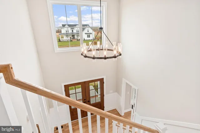 an empty room with a window and a ceiling fan