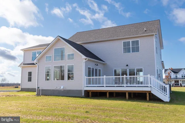 a front view of house with yard swimming pool and outdoor seating
