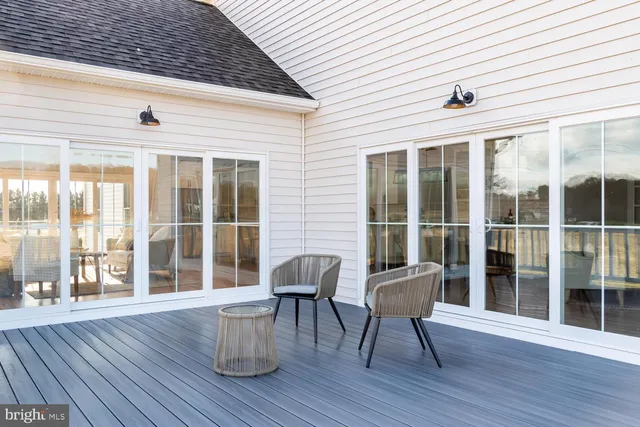 a view of a deck with table and chairs and wooden floor