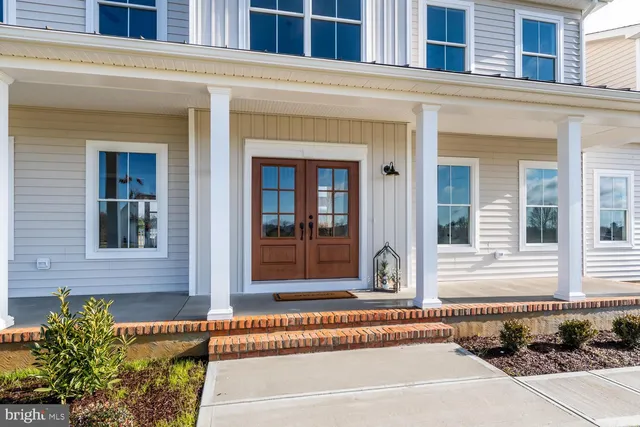 a view of staircase with lots of frames and frames on wall