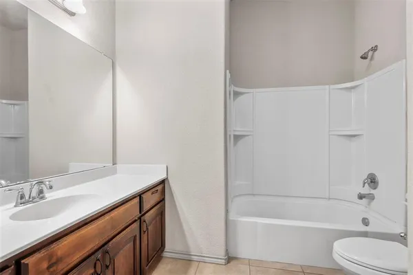 a bathroom with a sink a toilet and bathtub
