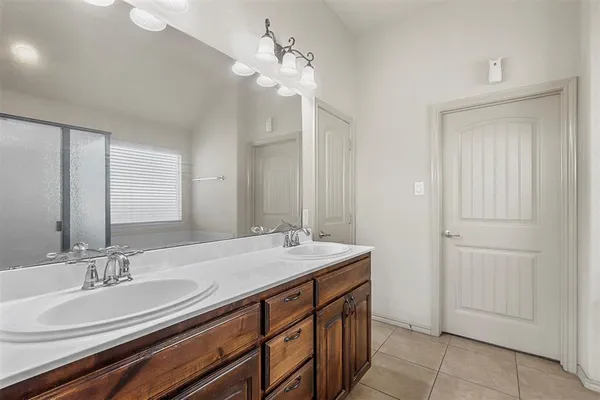 a bathroom with a sink double vanity and a mirror