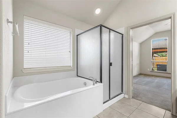 a bathroom with a bathtub and a shower