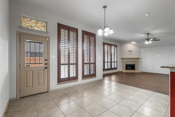 a view of a livingroom with a ceiling fan window and a fireplace