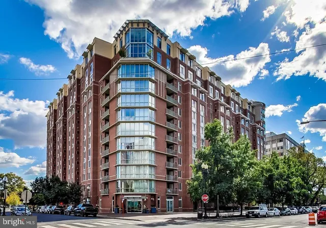 a view of a tall building next to a road
