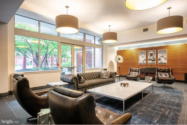 a view of a kitchen with kitchen island a sink a counter top space