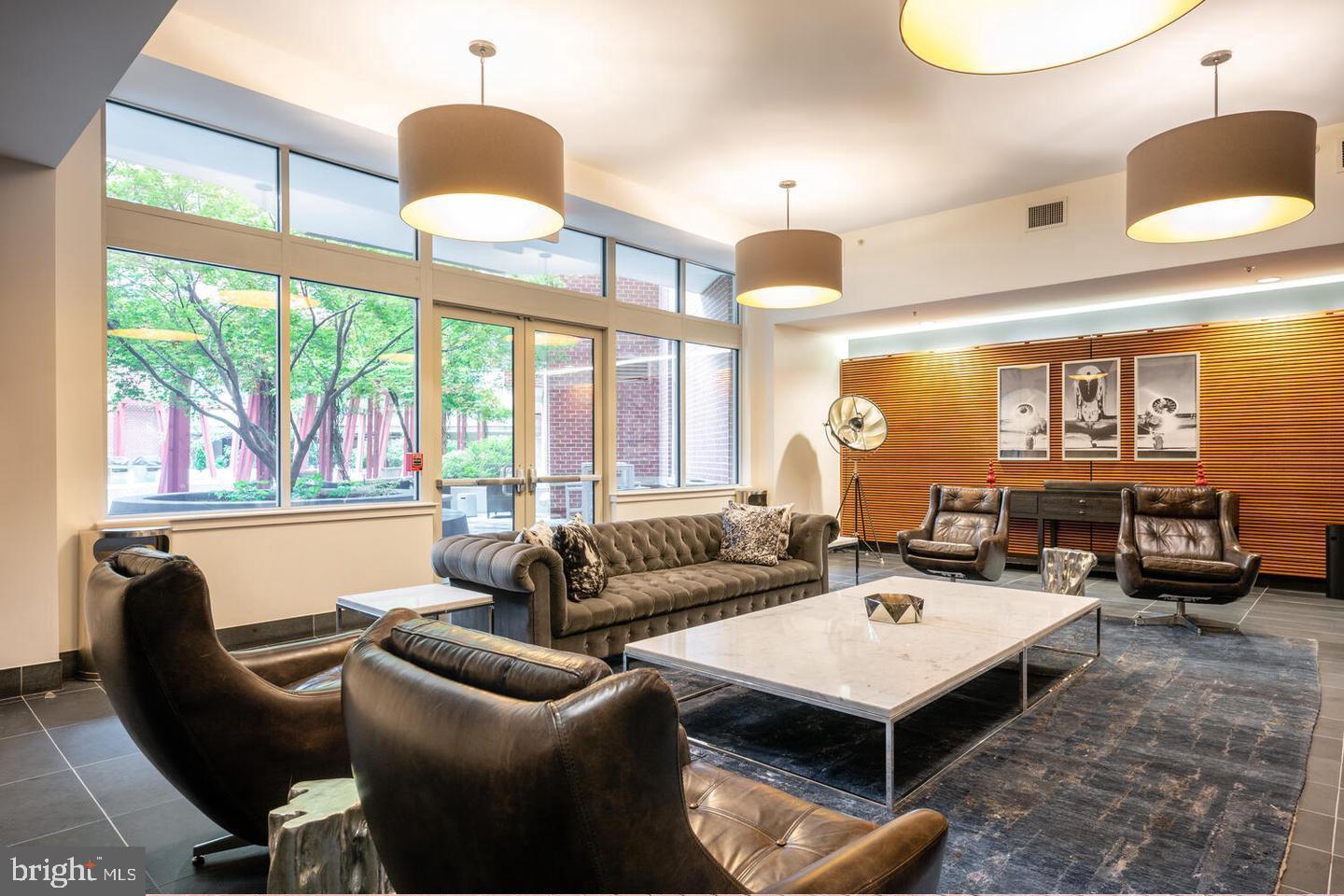 1000 New Jersey Avenue Southeast, Unit 107 Washington, DC 20003 - Photo 10 of 15 a living room with furniture and a large window