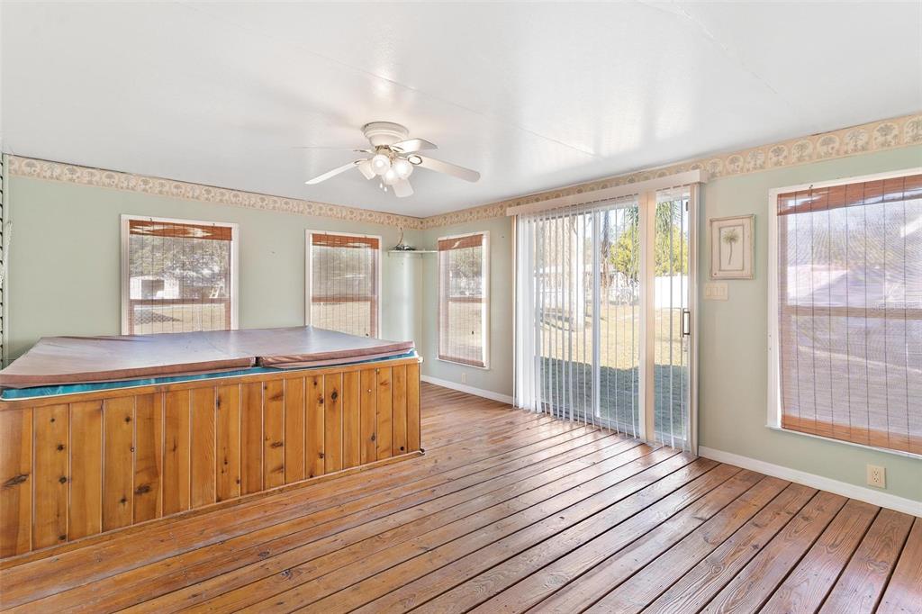 36832 Wilmington Road Fruitland Park, FL 34731 - Photo 14 of 14 an empty room with wooden floor and windows