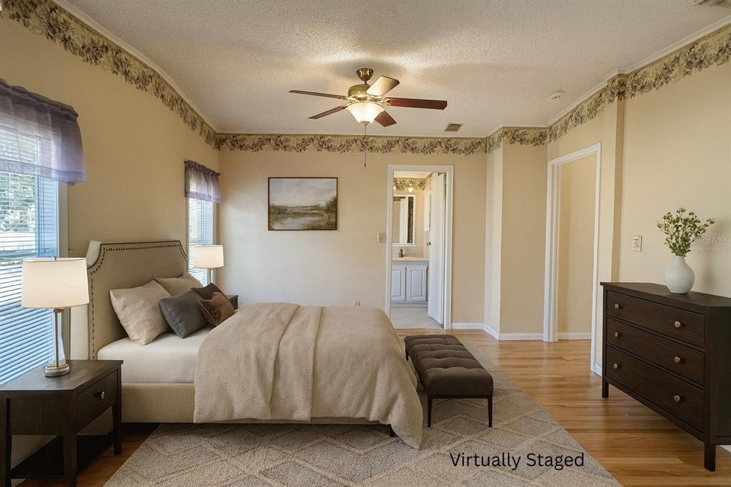 36832 Wilmington Road Fruitland Park, FL 34731 - Photo 4 of 14 a bedroom with a bed and wooden floor