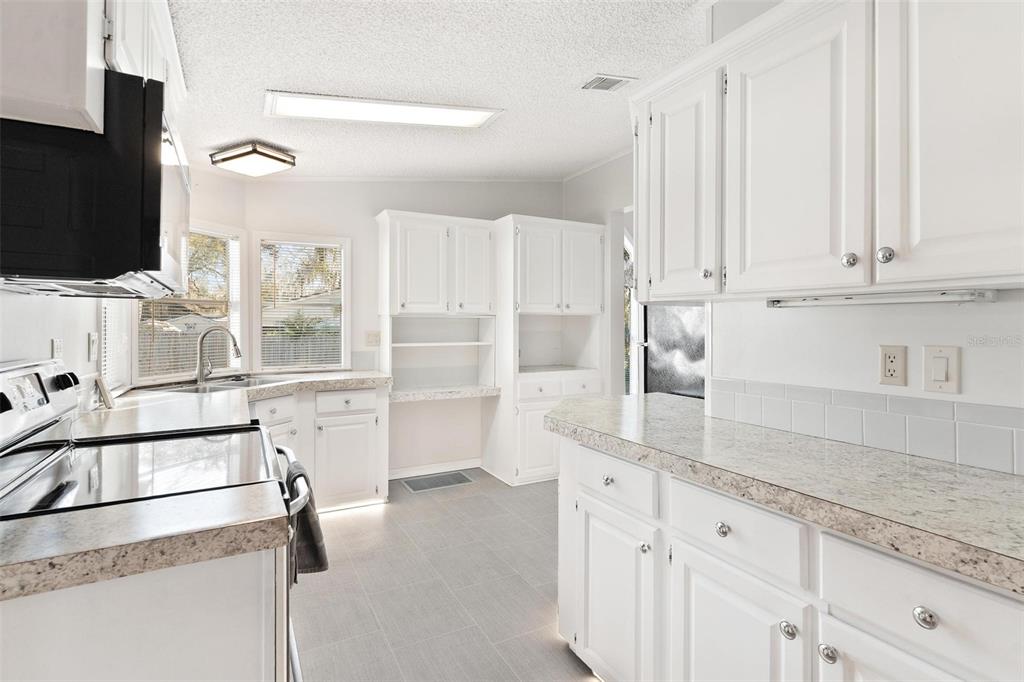 36832 Wilmington Road Fruitland Park, FL 34731 - Photo 6 of 14 a kitchen with stainless steel appliances cabinets and a counter top space