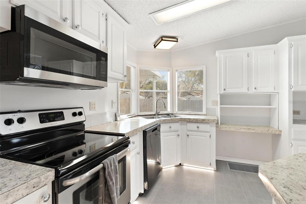 36832 Wilmington Road Fruitland Park, FL 34731 - Photo 7 of 14 a kitchen with a stove and a microwave