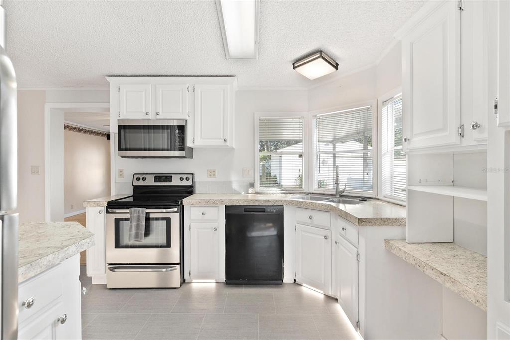 36832 Wilmington Road Fruitland Park, FL 34731 - Photo 8 of 14 a kitchen with a sink stove and microwave