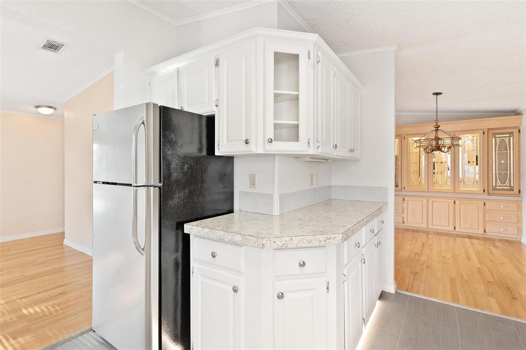 36832 Wilmington Road Fruitland Park, FL 34731 - Photo 10 of 14 a kitchen with stainless steel appliances granite countertop a refrigerator and a sink