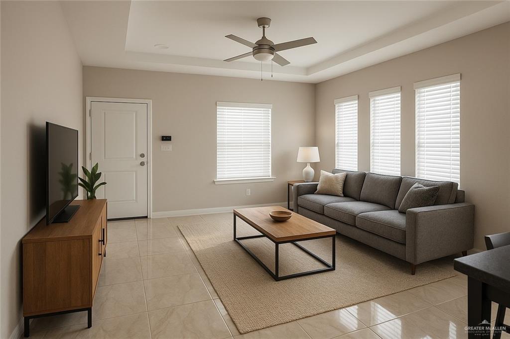 602 Mountain Road, Unit C Mission, TX 78573 - Photo 2 of 7 Living room featuring a tray ceiling, light tile patterned flooring, ceiling fan, and healthy amount of natural light