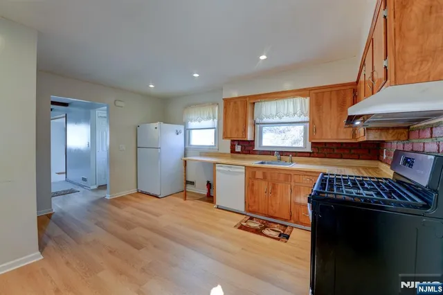 a view of kitchen with refrigerator and window
