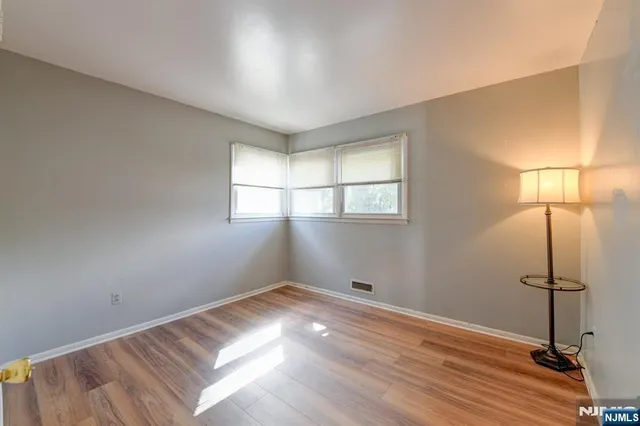 a view of a room with wooden floor and windows