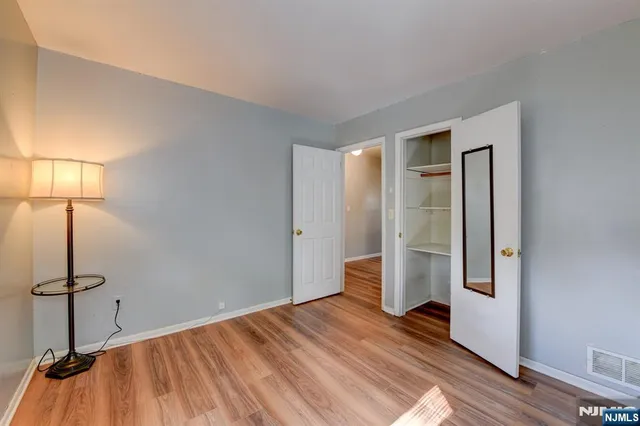 a view of a room with wooden floor