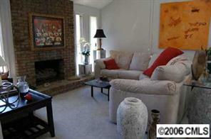 135 Hodgson Road Charlotte, NC 28211 - Photo 5 of 7 a living room with furniture a flat screen tv and a fireplace