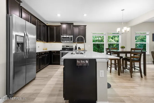 a kitchen with kitchen island granite countertop a stove refrigerator and cabinets