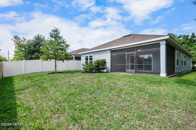 a view of a house with yard and a garden