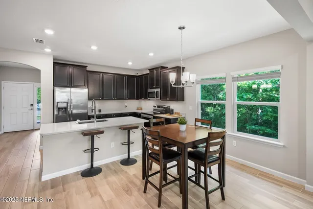 a kitchen with a table and chairs in it