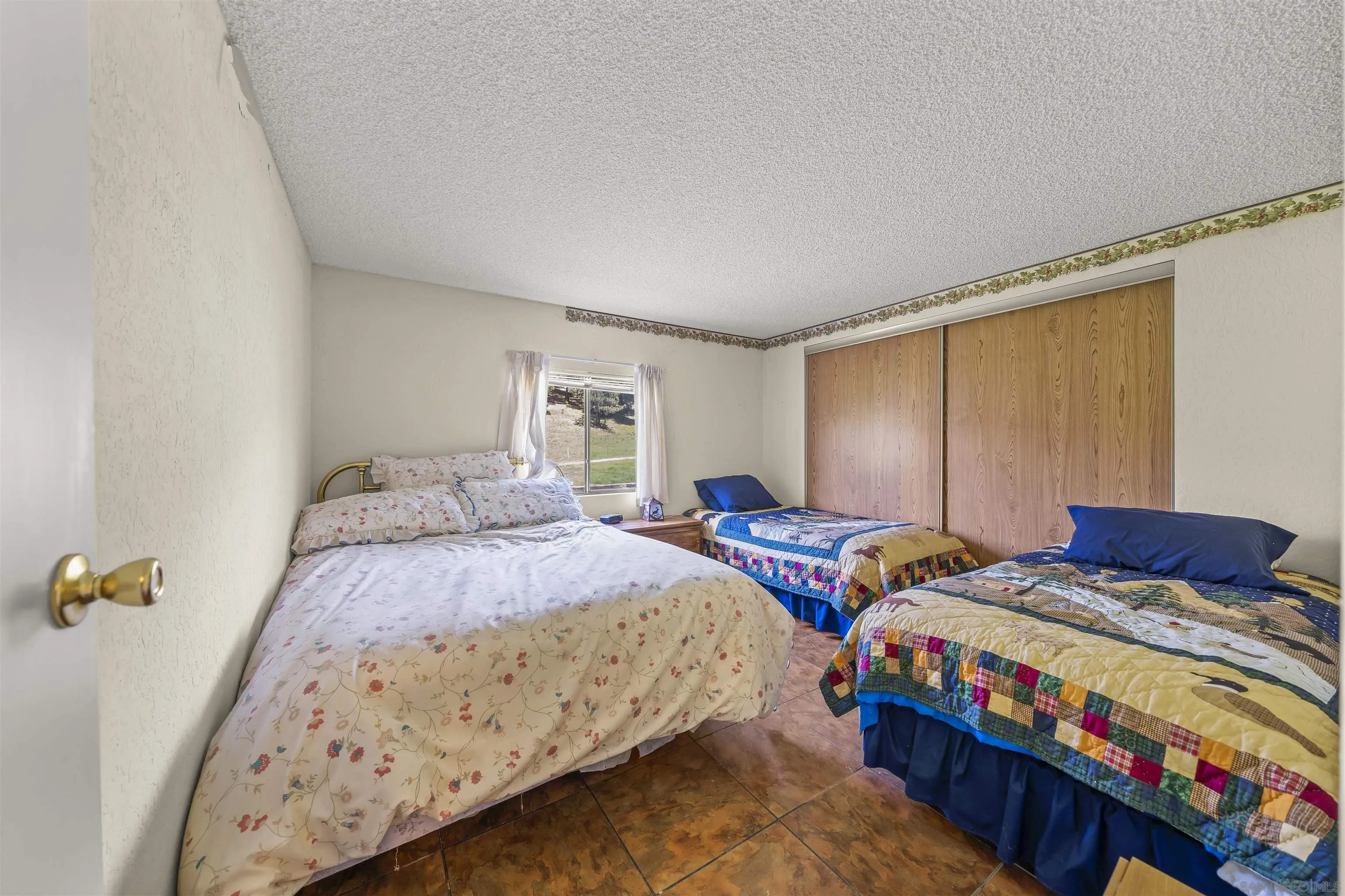 2464 Wynola Road Julian, CA 92036 - Photo 30 of 50 a bedroom with two beds and a table
