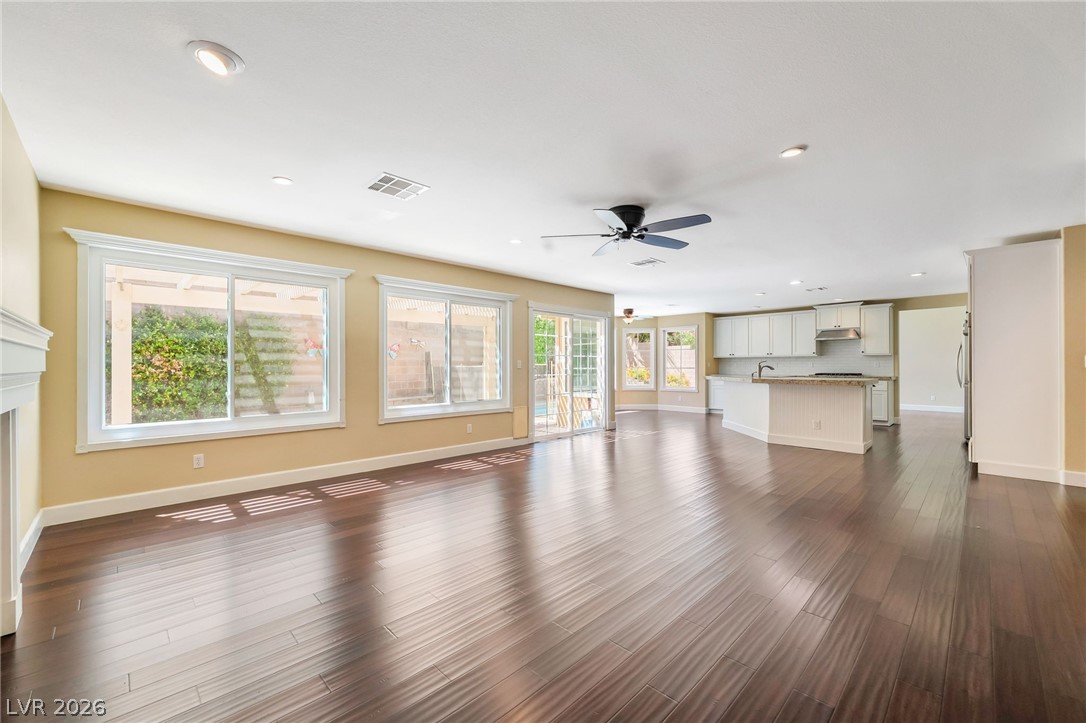 271 Pointe Ranier Avenue Henderson, NV 89012 - Photo 8 of 26 This expansive open concept space features hardwood floors and a view of the backyard.